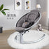 Gray quilted baby rocker chair in modern nursery with plush rug and decor