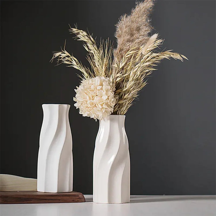 Modern ceramic vase with dried pampas grass and flower on minimalist table