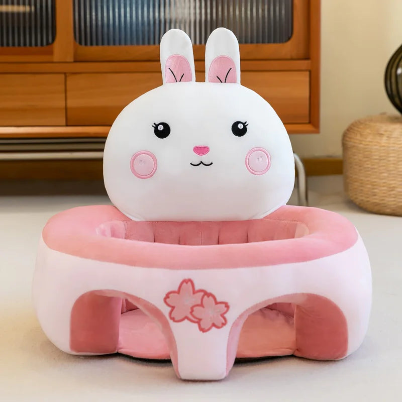 Plush pink and white bunny baby floor seat with cute floral design in a cozy room setting