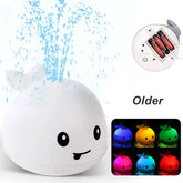 Cute whale bath toy spraying water, battery operated, with multicolor LED lights.