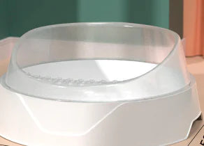 White pet water bowl with transparent splash guard on a tabletop