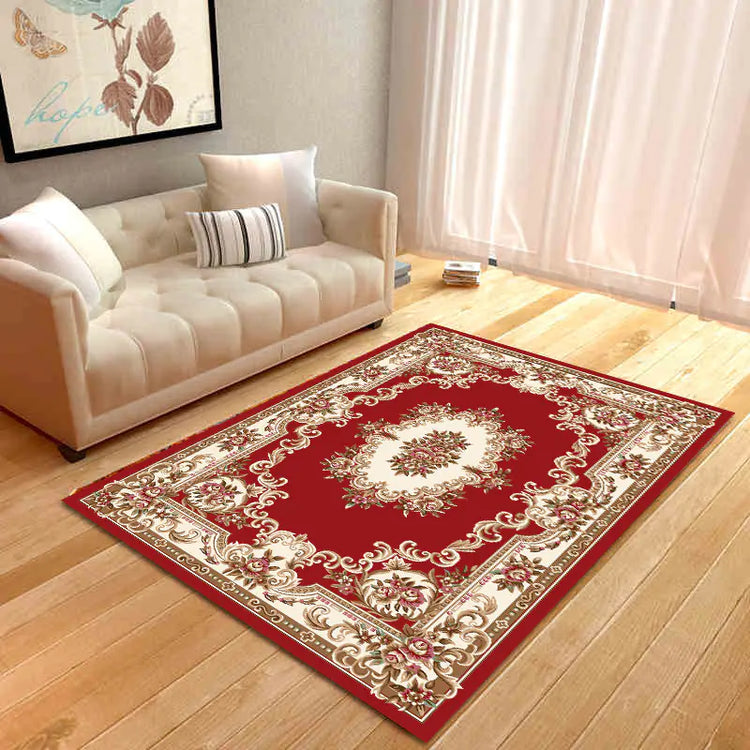 Elegant red and beige floral area rug in modern living room with cream sofa and wall art