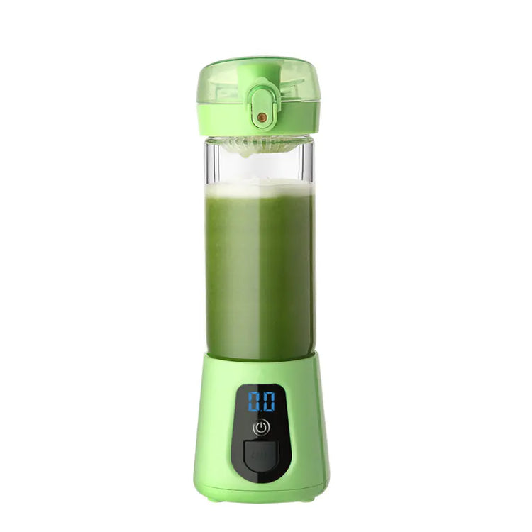 Green portable blender with digital display, filled with green smoothie, on white background.