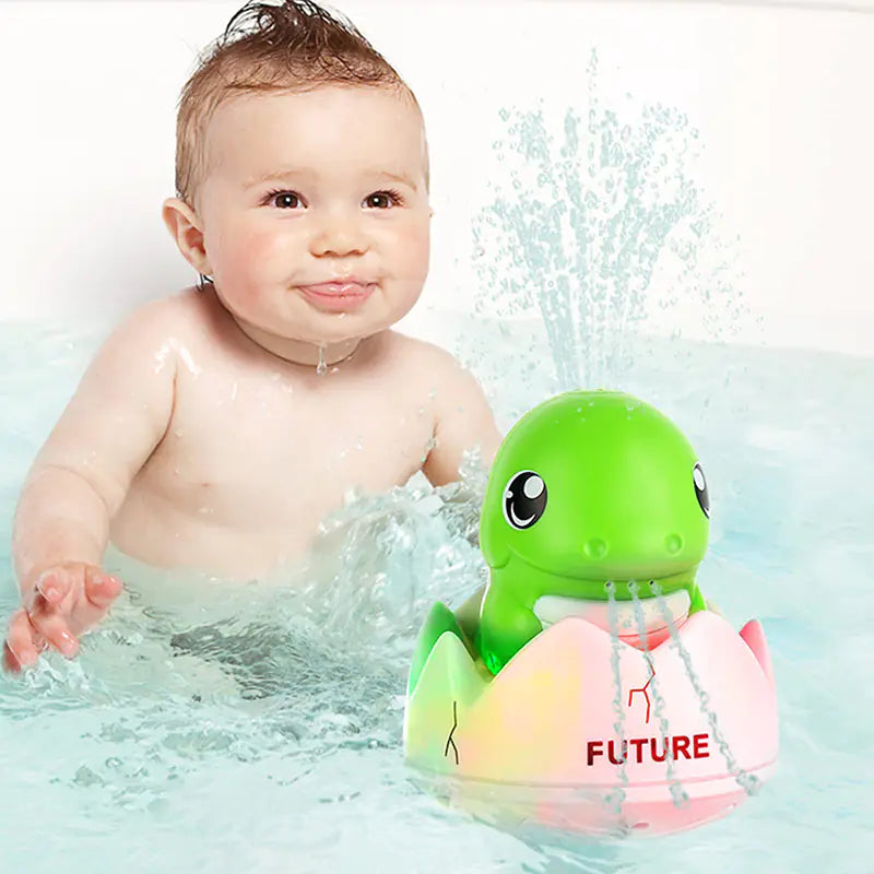 Smiling baby in bath with green turtle bath toy spraying water, colorful egg shell labeled FUTURE