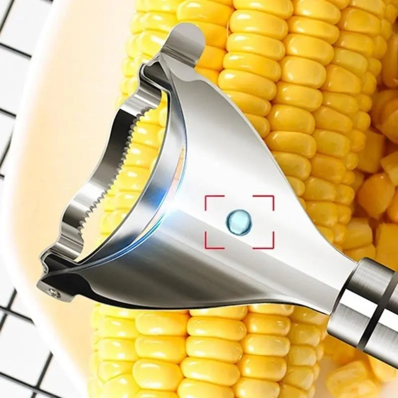 Stainless steel corn peeler tool removing kernels from fresh corn cob