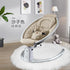 Beige baby rocker chair with harness in modern nursery, plush rug, and soft lighting
