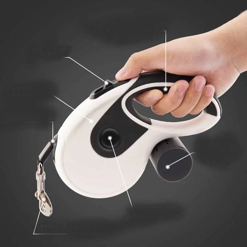 Hand holding retractable dog leash with ergonomic handle and detachable waste bag holder