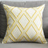 Yellow geometric pattern throw pillow on gray sofa
