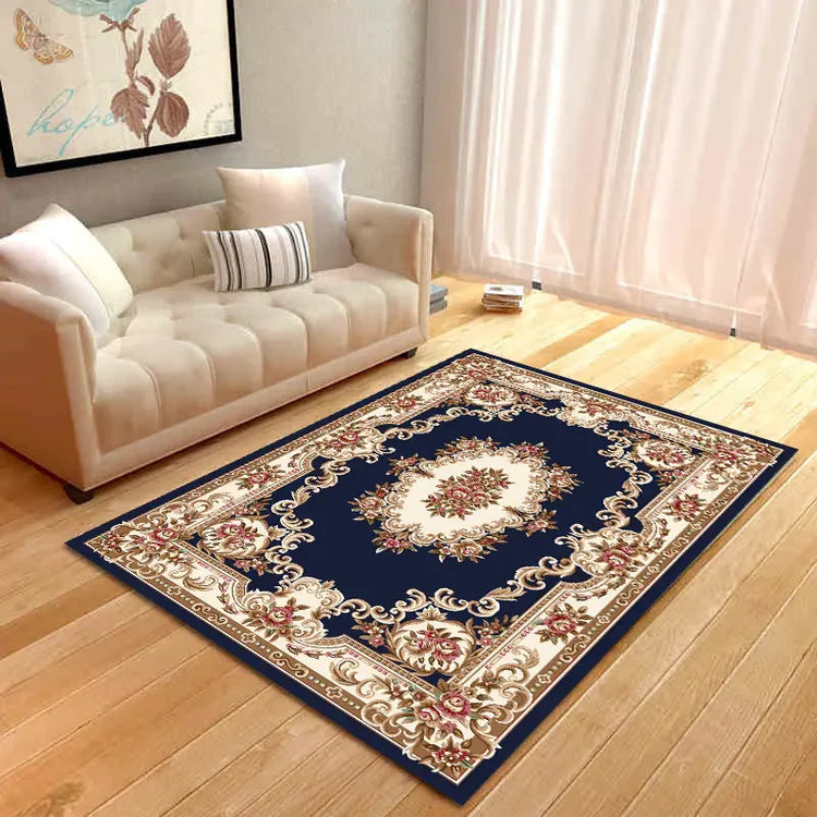Elegant living room with cream sofa and ornate navy floral area rug on wooden floor