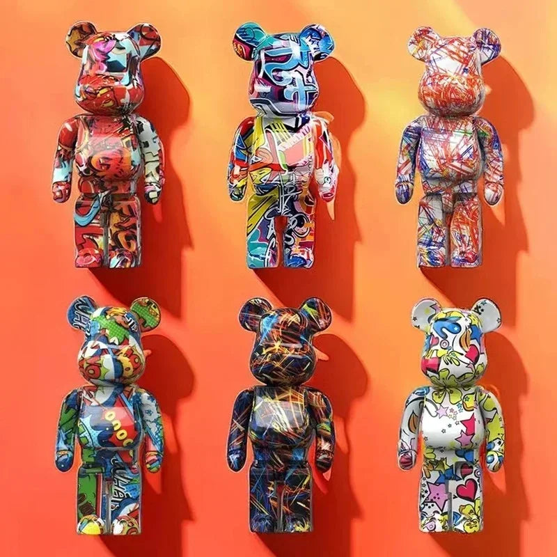 Six colorful graffiti-style Bearbrick figures displayed on an orange background