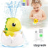 Baby playing with dinosaur egg bath toy that sprays water, USB charging cable shown