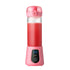 Pink portable blender with digital display blending red smoothie
