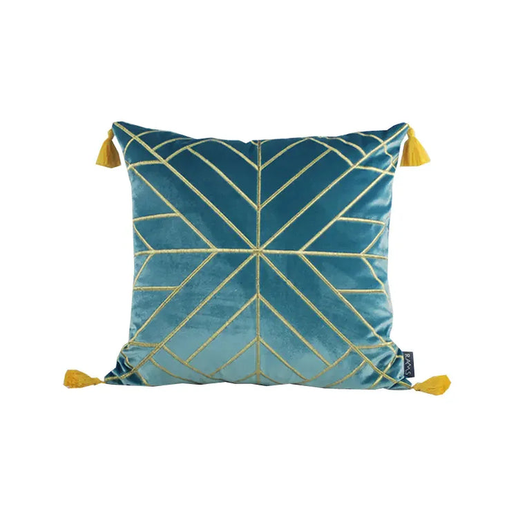 Blue velvet throw pillow with gold geometric lines and yellow tassels on each corner
