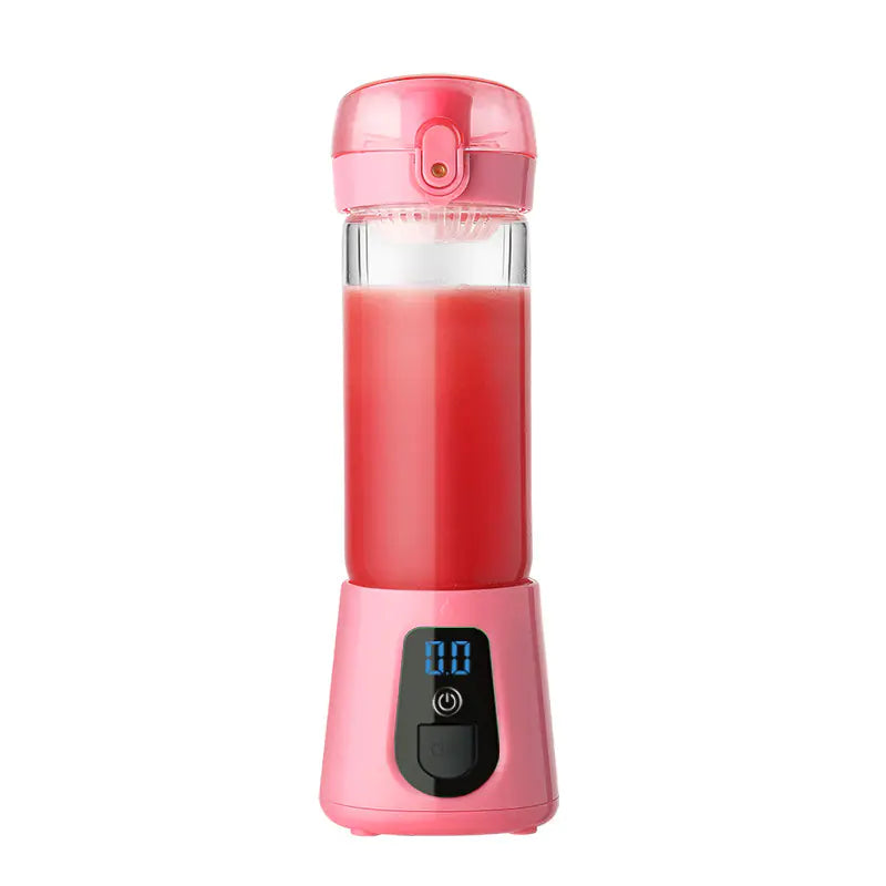 Pink portable blender with digital display filled with red smoothie on white background