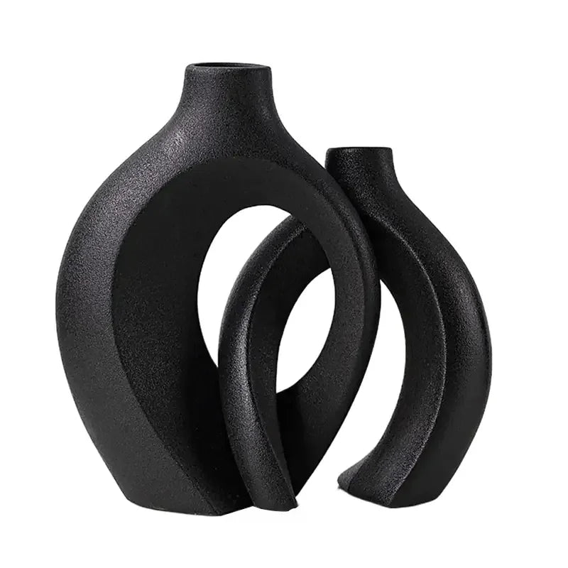 Modern black ceramic vases with abstract geometric design on white background