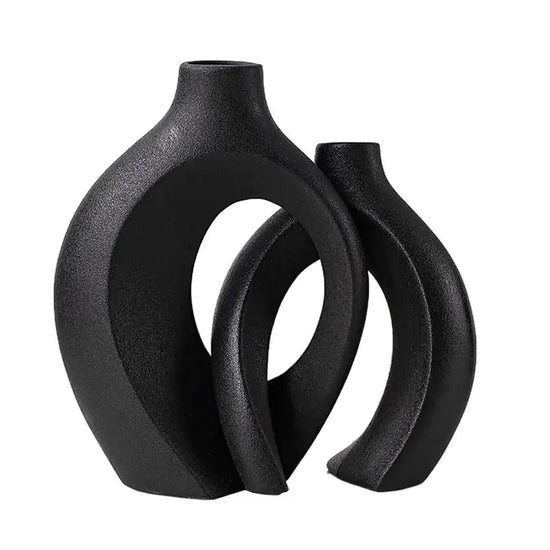Modern black ceramic vases with abstract geometric design on white background