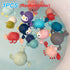 Assorted animal bath toys floating in water, including crabs, penguins, turtles, and whales