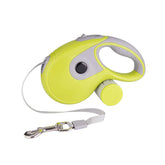 Yellow retractable dog leash with ergonomic handle and attached waste bag holder