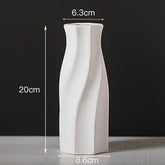 White ceramic vase with twisted design, 20cm tall, 6.3cm top, 8.6cm base, on grey surface