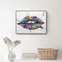 Colorful graffiti lips wall art above white console with vase and wicker basket