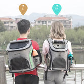Man and woman outdoors wearing large and medium gray pet carrier backpacks