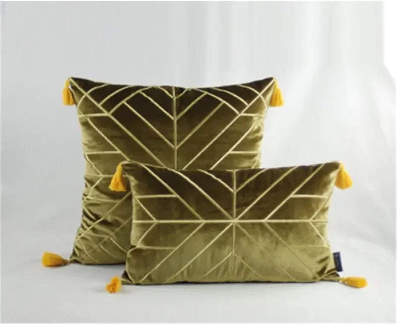 Olive green velvet cushions with geometric patterns and yellow tassel accents